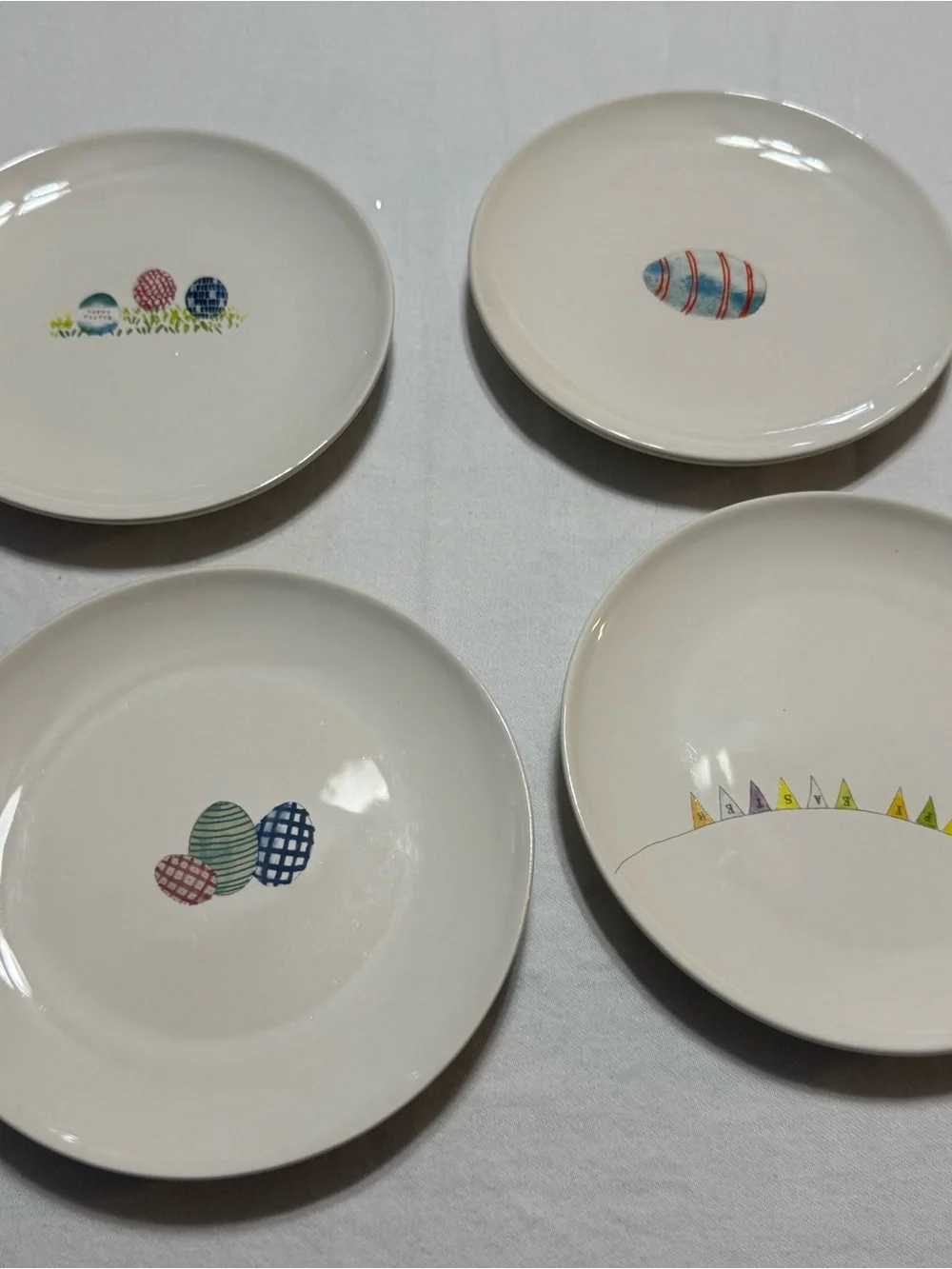 Rae Dunn White Ceramic Accent Plates with Multicolor Egg Motifs